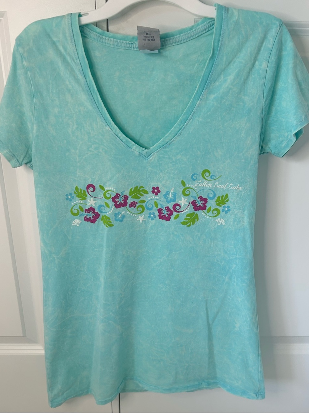 Women's medium EMI cyan V-Neck shirt with Floral design.